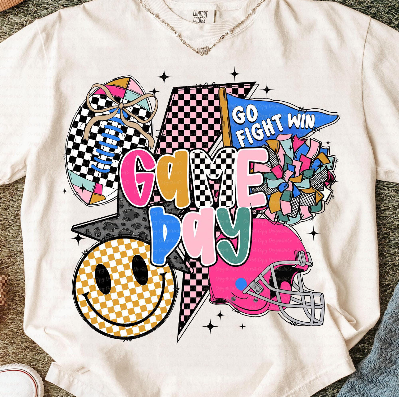 Show your team spirit in style with our Game Day Graphic Tee! 🎉 This vibrant design features a mix of playful patterns and bold colors—checkerboard football, cheer pom poms, smiley face, helmet, and “Go Fight Win” flag—all brought together with fun, retro lettering that pops. Printed on a premium Comfort Colors tee for that soft, lived-in feel you’ll love from the first wear. Perfect for football season, pep rallies, tailgates, or simply repping your favorite team in everyday style.