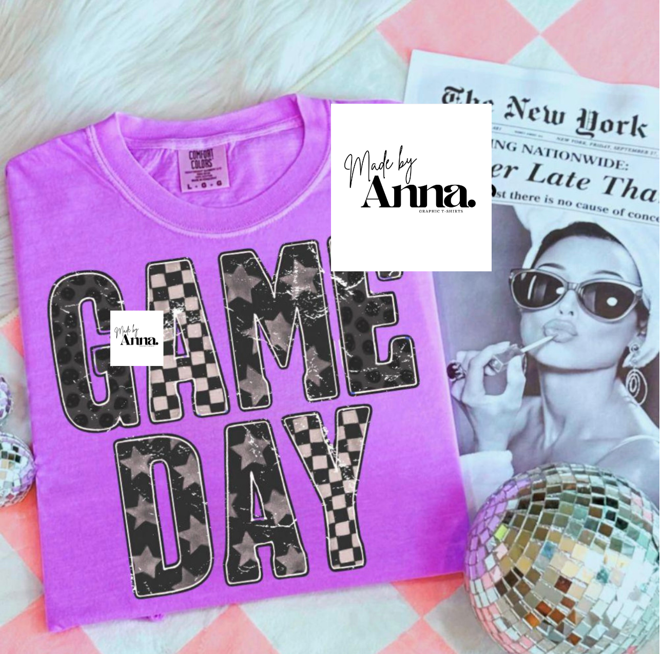 Purple t-shirt with 'GAME DAY' text on a checkered background, featuring a small inset of a woman and the brand 'Made by Anna'.